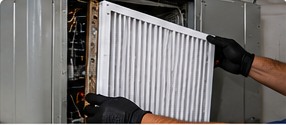 Air filter being replaced in commercial equipment